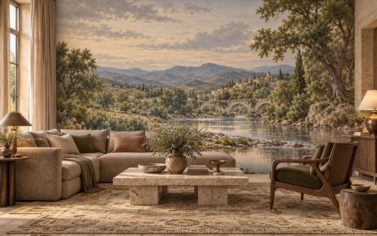 Le Crépuscule d’Arcadie river mural with a stone bridge, hillside village and muted evening sky in a styled room