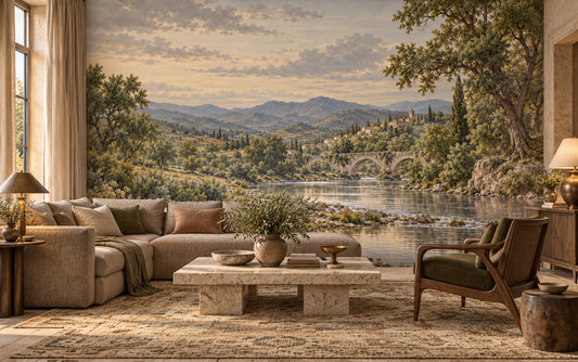 Le Crépuscule d’Arcadie river mural with a stone bridge, hillside village and muted evening sky in a styled room